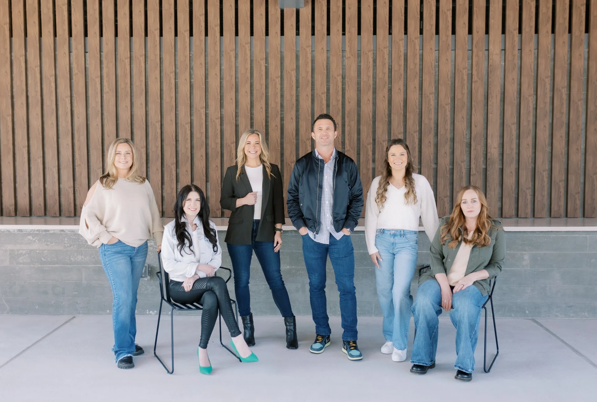 The Tyroch Team — six team members against a wood-slat wall